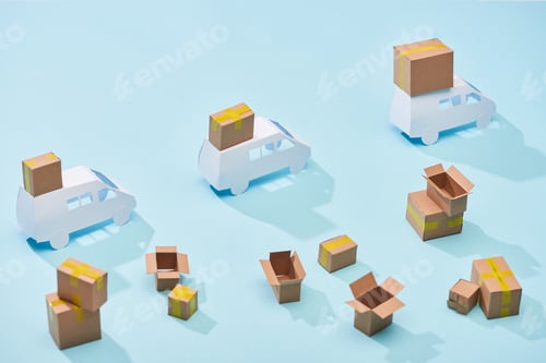 Preview: white mini vans with closed cardboard parcels near boxes on blue background