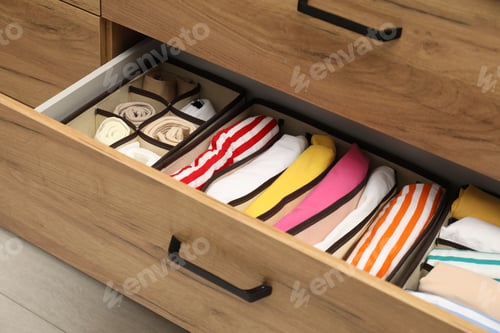 Preview: Organizers with folded clothes in drawer indoors, closeup