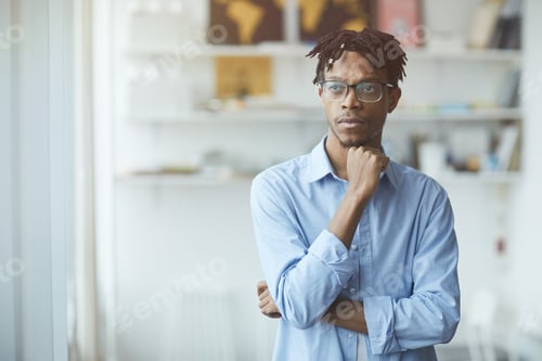 Preview: Thoughtful Man Posing Indoors with Hand on Chin