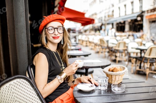 Preview: Woman having a french breakfast at the cafe