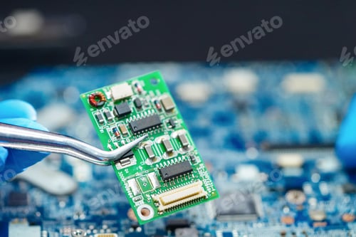 Preview: E-waste, technician repairing inside of hard disk by soldering iron.