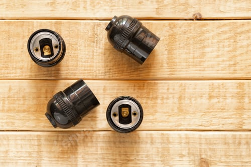 Preview: Four Black Light Bulb Sockets On Wood