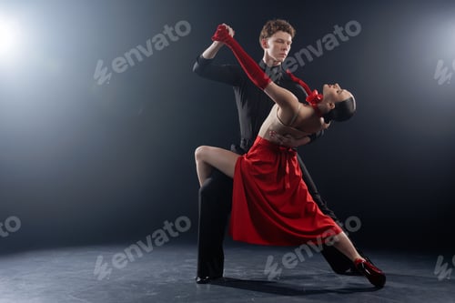 Preview: Dance Couple Performing Dramatic Partner Pose in Studio with Controlled Lighting