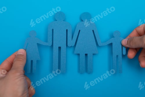 Preview: Overhead of a person holding paper family figures
