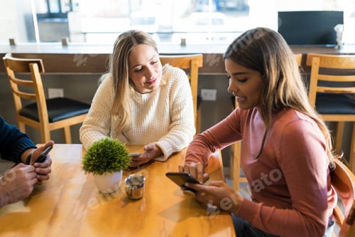 Preview: Friends With Mobile Phones Spending Leisure Time At Cafe