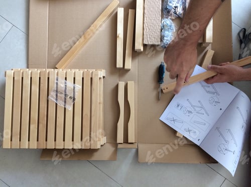 Preview: Man putting together furniture DIY