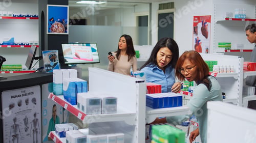 Preview: Female pharmacist helping asian client to find medicaments