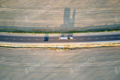 Preview: Aerial view of intercity road with fast driving cars at sunset. Top view from drone of highway