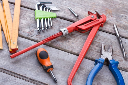 Preview: Construction tools on rustic wooden background.