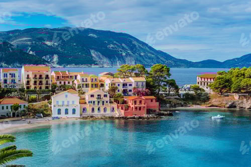 Preview: Beautiful panoramic view of Assos village with vivid colorful houses near blue turquoise colored and