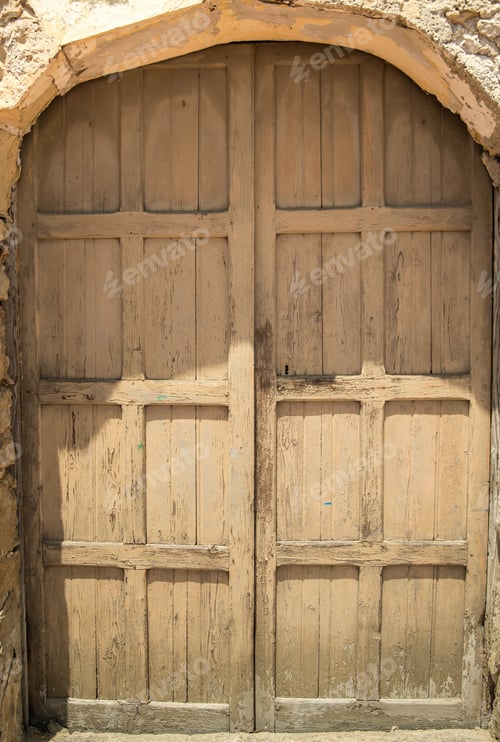 Weathered Wooden Doorway with Stone Arch