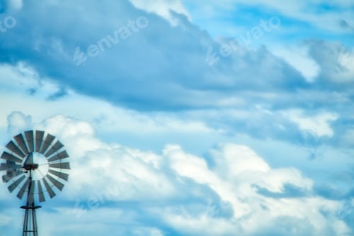 Preview: Windmill against a beautiful blue cloudy background in New Mexico