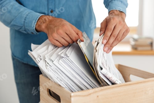 Preview: Young white man working with drawings in box at office