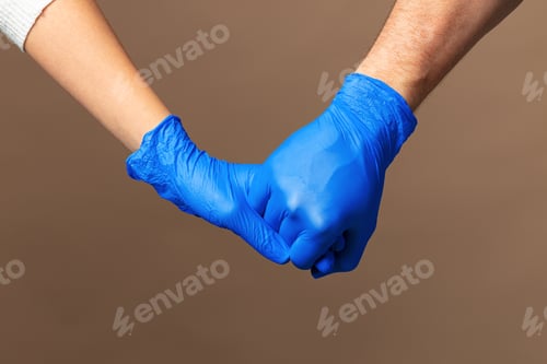 Preview: Handshake in a blue gloves, help concept. Personal hygiene during a pandemic
