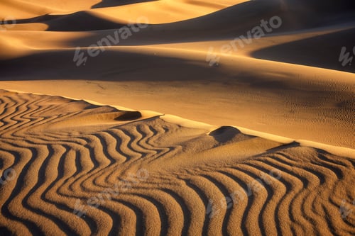 Preview: the sand dunes and sunset glow on them in the desert