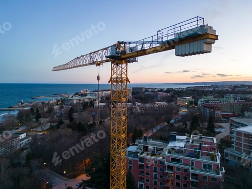 Preview: Busy Construction Site and Construction Equipment at night. Aerial view