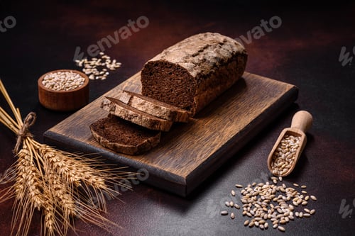 Preview: A loaf of brown bread with grains of cereals on a wooden cutting board