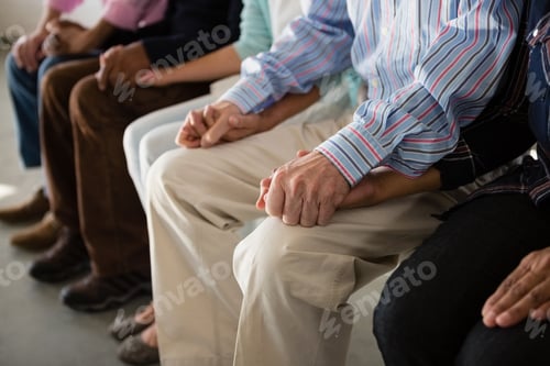 Preview: Supportive People Holding Hands in a Group Setting