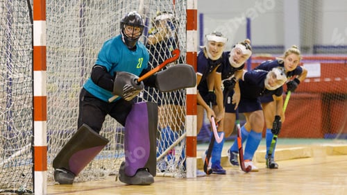 Preview: Goalkeeper and her teammates defence the net from the corner shot in indoor hockey game