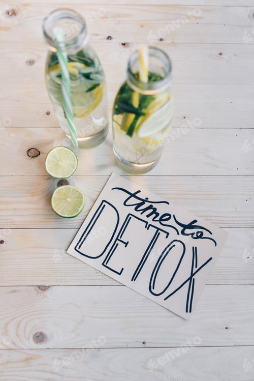 Preview: top view of time to detox card and detox drinks with citrus on wooden tabletop