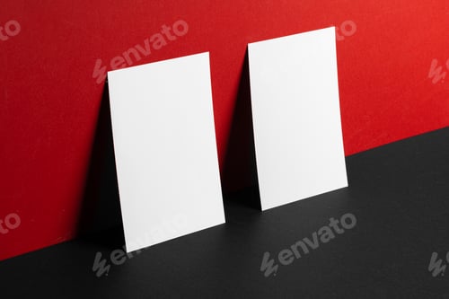 Preview: Blank white business cards on red and black paper background