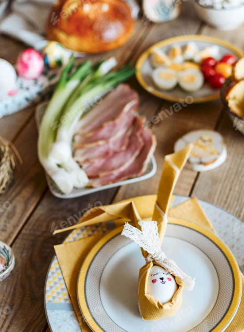 Preview: Easter holiday food on wooden table. Easter eggs, decorations, tablescape.