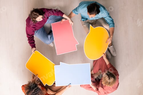 Preview: View of four young web designers in casualwear choosing form of speech bubble