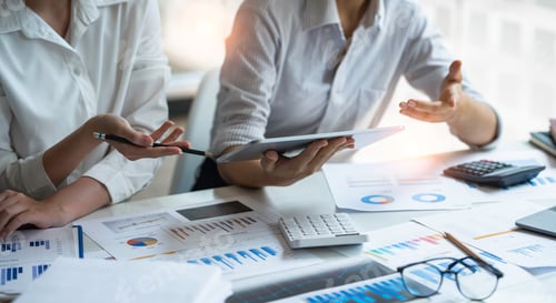 Preview: Businessmen holding pens and graph paper are meeting to plan sales to analyze investment results and
