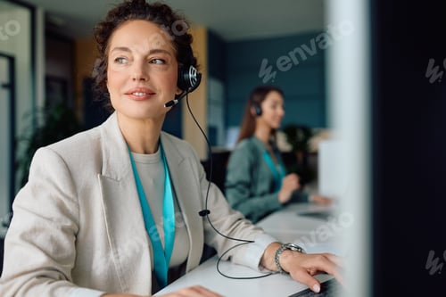 Preview: Female customer support representative working on desktop PC in the office.
