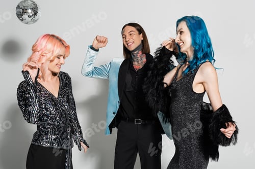 Preview: joyful and elegant queer people celebrating christmas and dancing on grey background