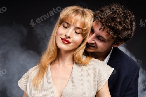 Preview: Man in a suit is kissing a woman with red lips