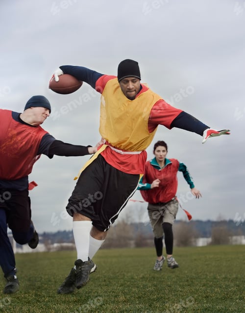 Preview: Black man running with the football and being chased by opponents in a non-contact flag football