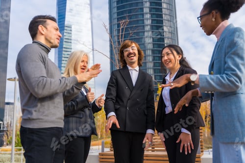 Preview: Group of middle-aged multi-ethnic businessmen and businesswomen in a business park, talking to each