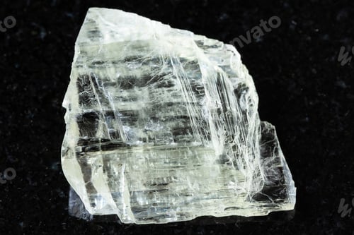 Preview: sample of rough spodumene mineral on black granite