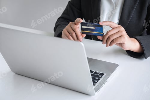 Preview: Professional using Credit Card and Laptop for Payment