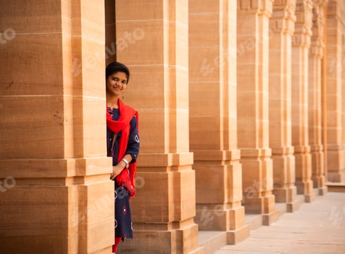 Preview: Indian woman standing between arches and Pillars.