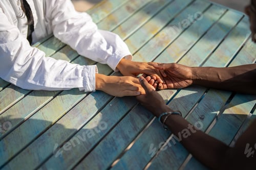 Preview: Two people hold hands in the warm sunlight, expressing love, trust, and deep emotional support