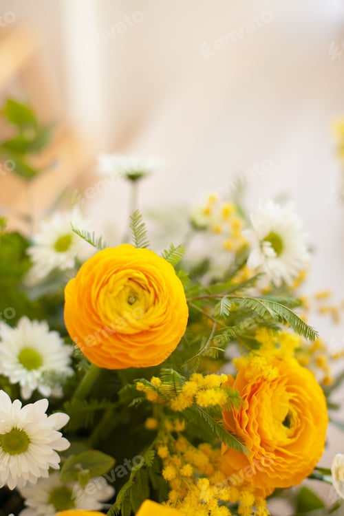 Preview: yellow flowers spring or summer florist arrangement on the table closeup