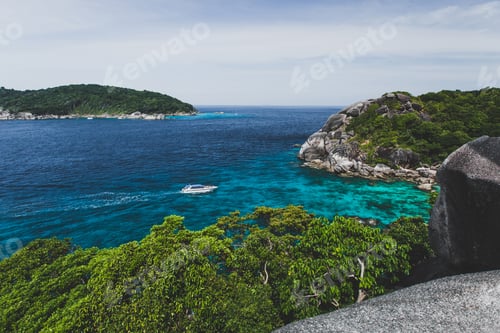 Preview: Touristic speedboat near island shore with turquoise clear transparent water. Idyllic view