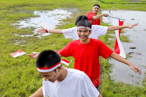 Preview: Young People Celebrate Indonesian Independence Day, Holding Flags And Walking Proudly