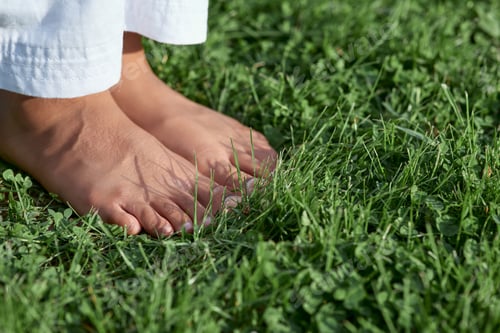 Preview: Barefoot Afro American girl standing on green grass