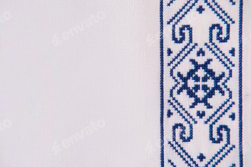 Preview: Texture of homespun linen textile with embroidery. Design of ethnic pattern. Craft embroidery.