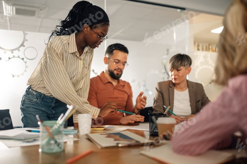 Preview: Marketing team analyzing graphs and discussing new project during a meeting
