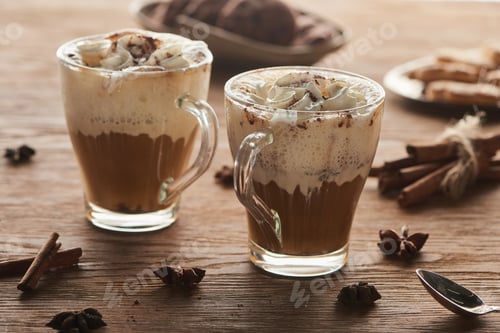 Preview: Christmas cacao with whipped cream on wooden table with spices