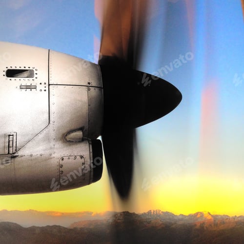 Preview: Side view of a plane propeller during a flight with sky and mountains background at sunrise