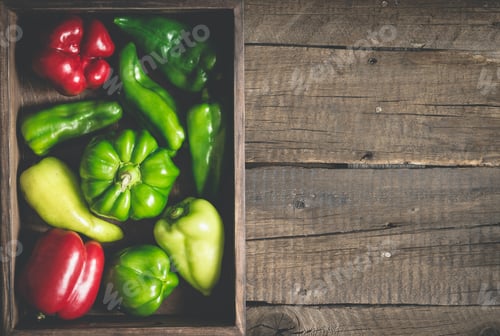 Preview: variety red and green bell peppers of various shapes. Full vegetable tray On a wooden background