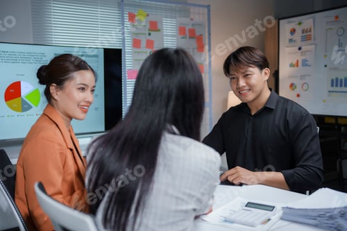 Preview: Asian businesspeople discussing marketing strategy during meeting in office