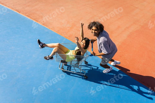 Preview: Multiracial group of young friends bonding outdoors