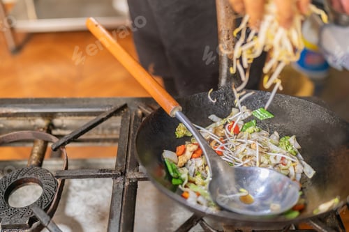 Preview: Chef adding bean sprouts to pan with vegetables and chicken