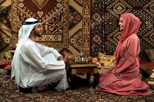 Preview: Young couple from Emirati spending time in a cafe